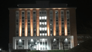 Outside view of lit campus building at night