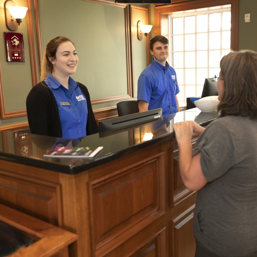 StFX Hotel Staff talking with customer