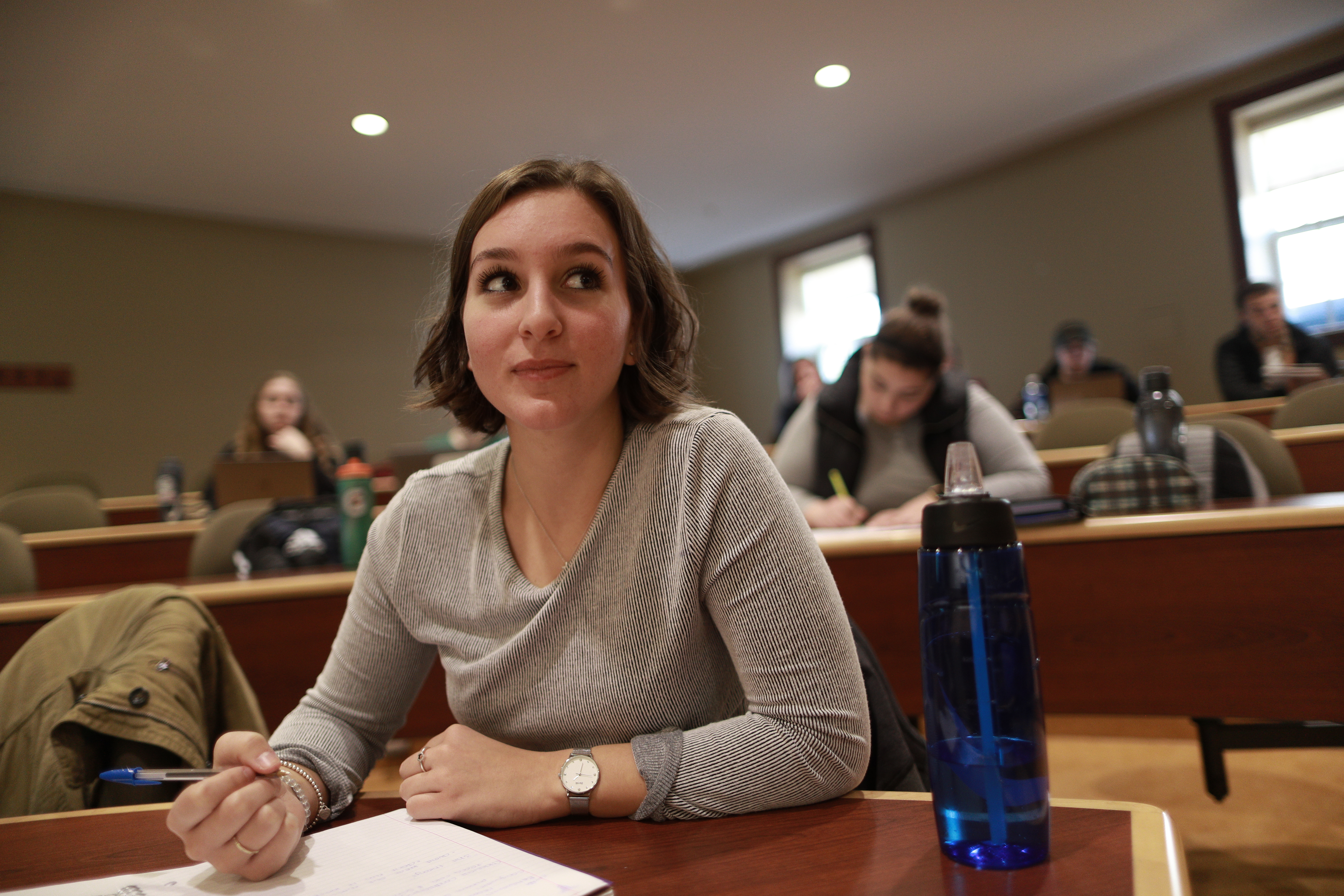 Student taking notes in class