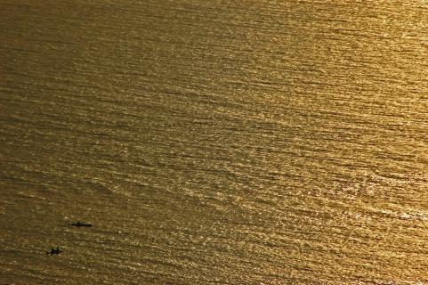 zoomed out picture of a boat in the ocean