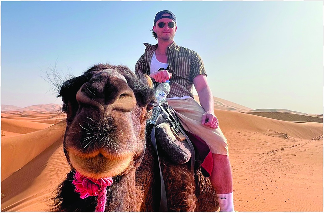 Student riding camel