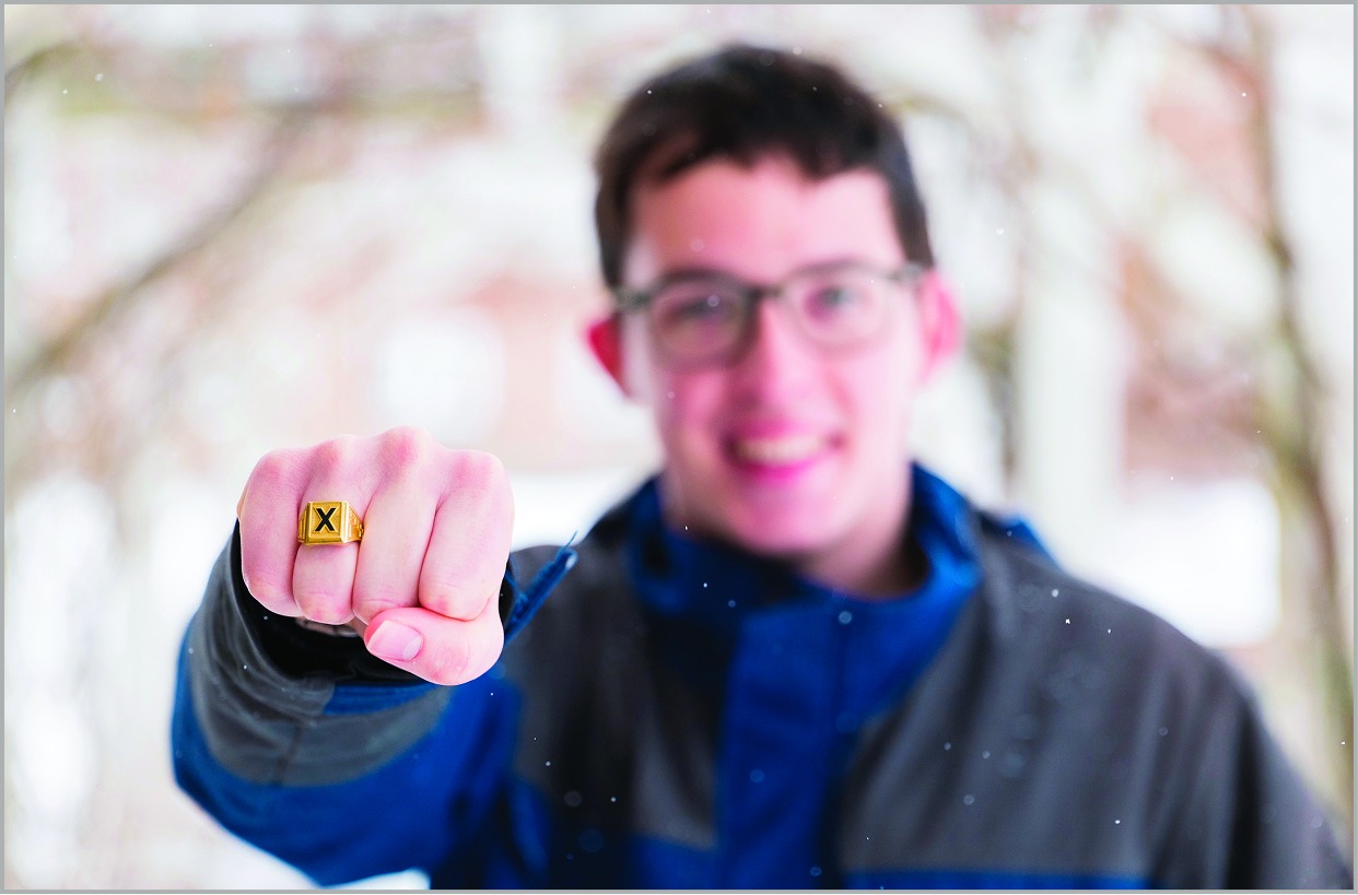 Student displaying his X-Ring