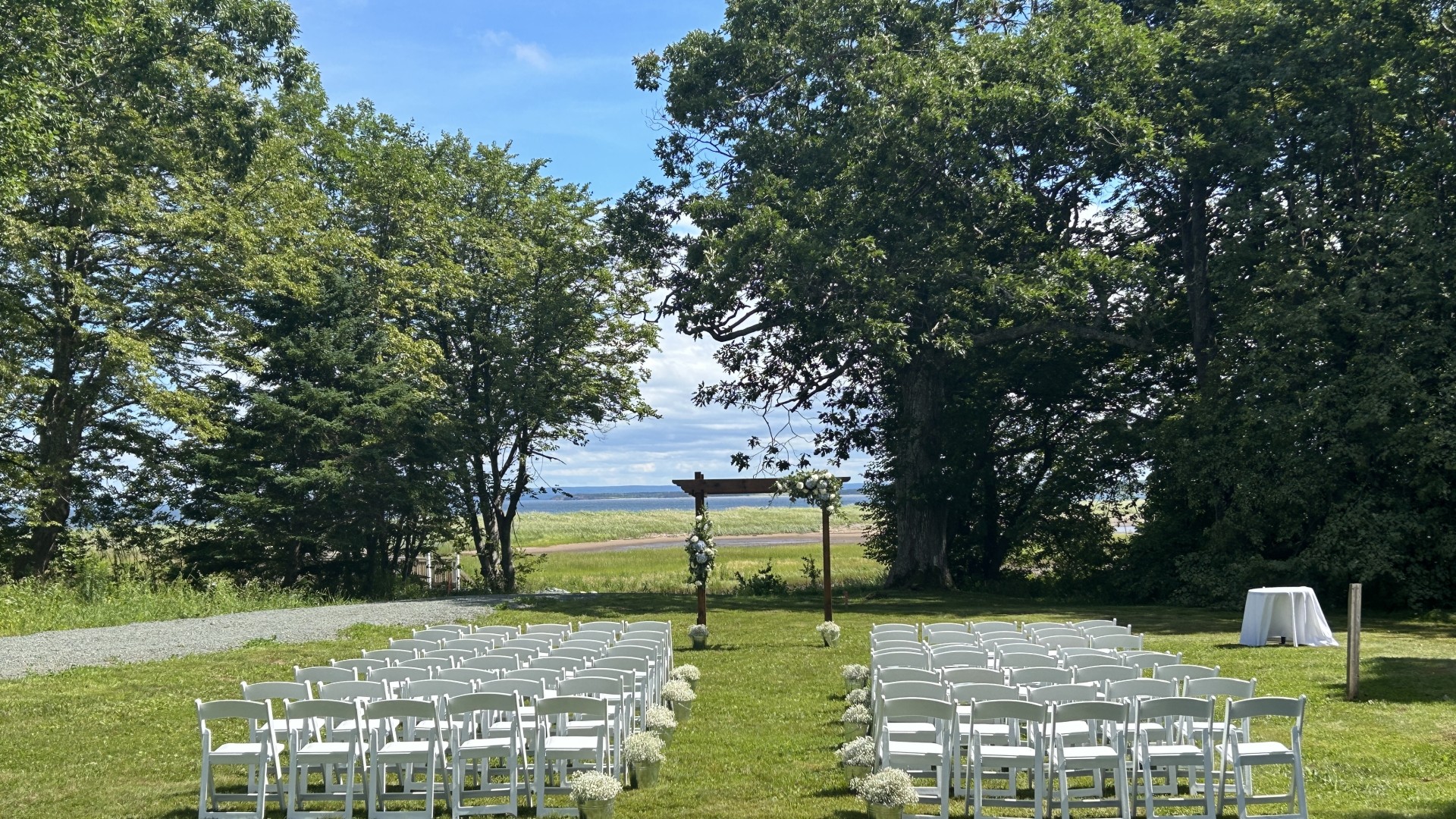 Chairs and an arch set up for an outdoor wedding