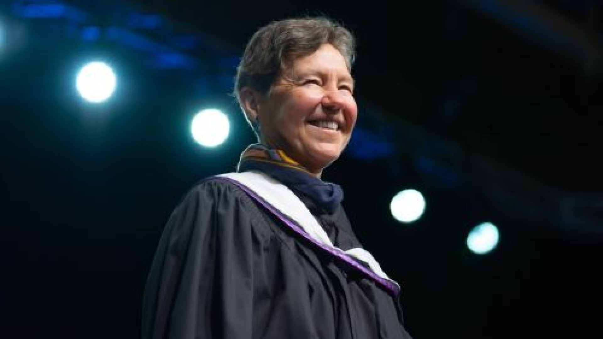 Dr. Vincent smiles on stage at Convocation 2026.