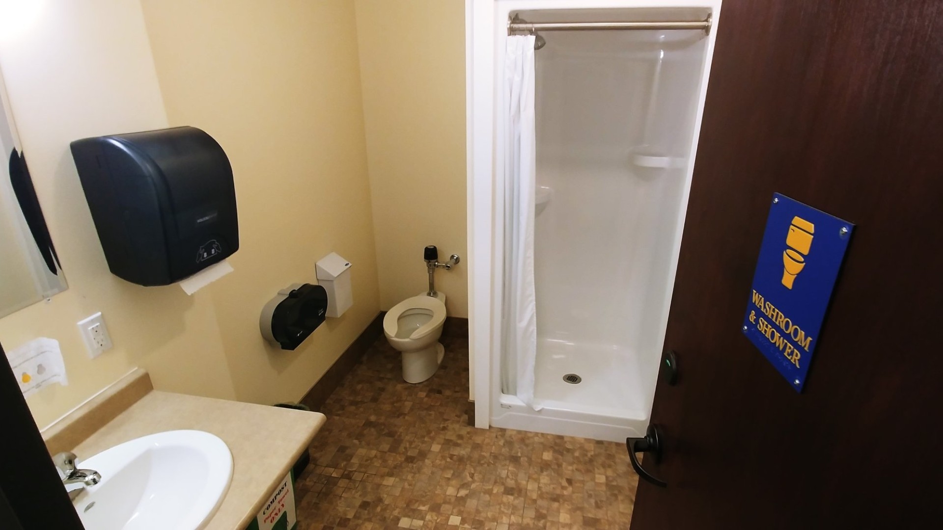 Washroom with a shower, sink and toilet 