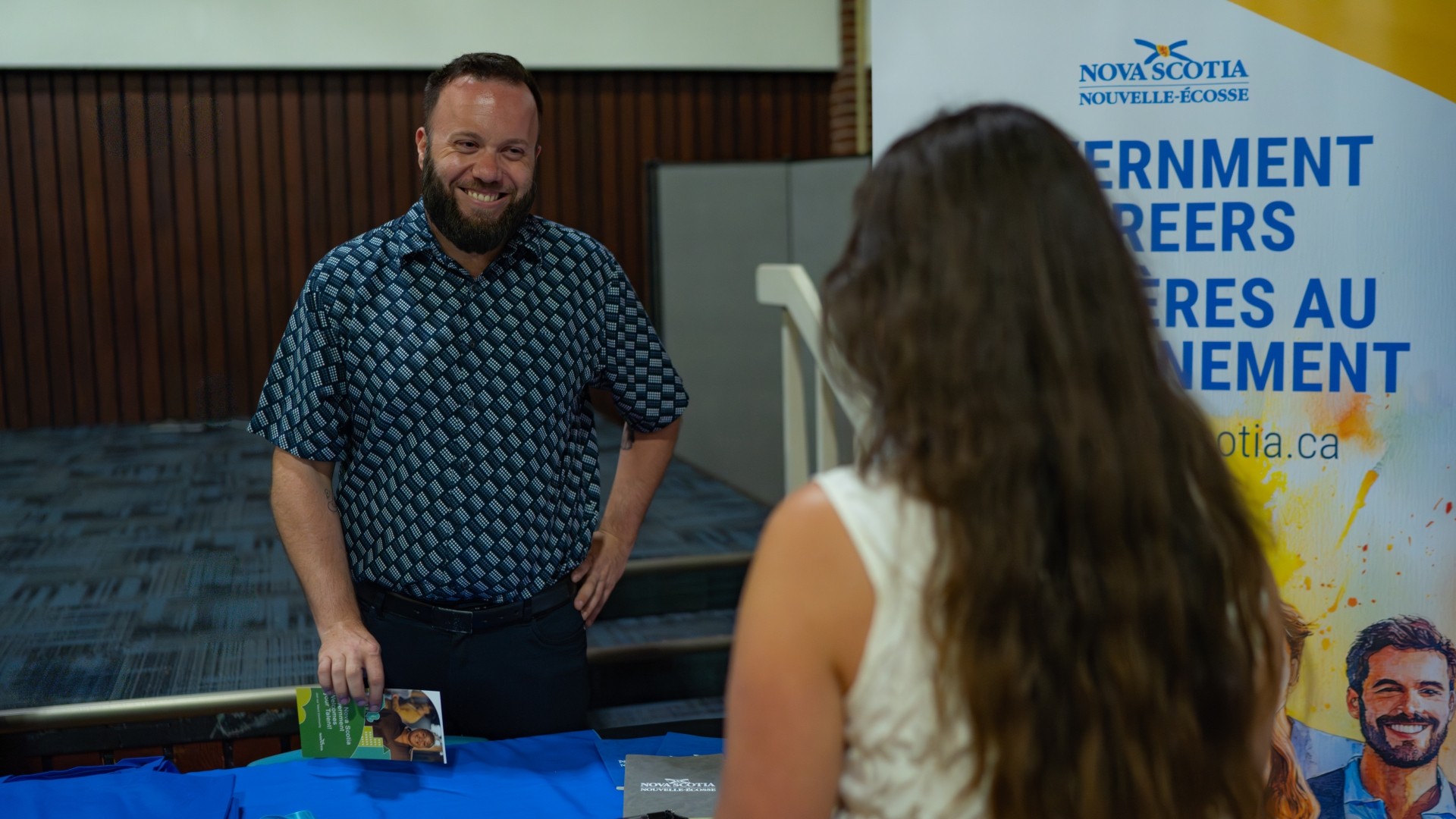 A man and women strike a conversation at the 2025 Opportunities Fair 2025