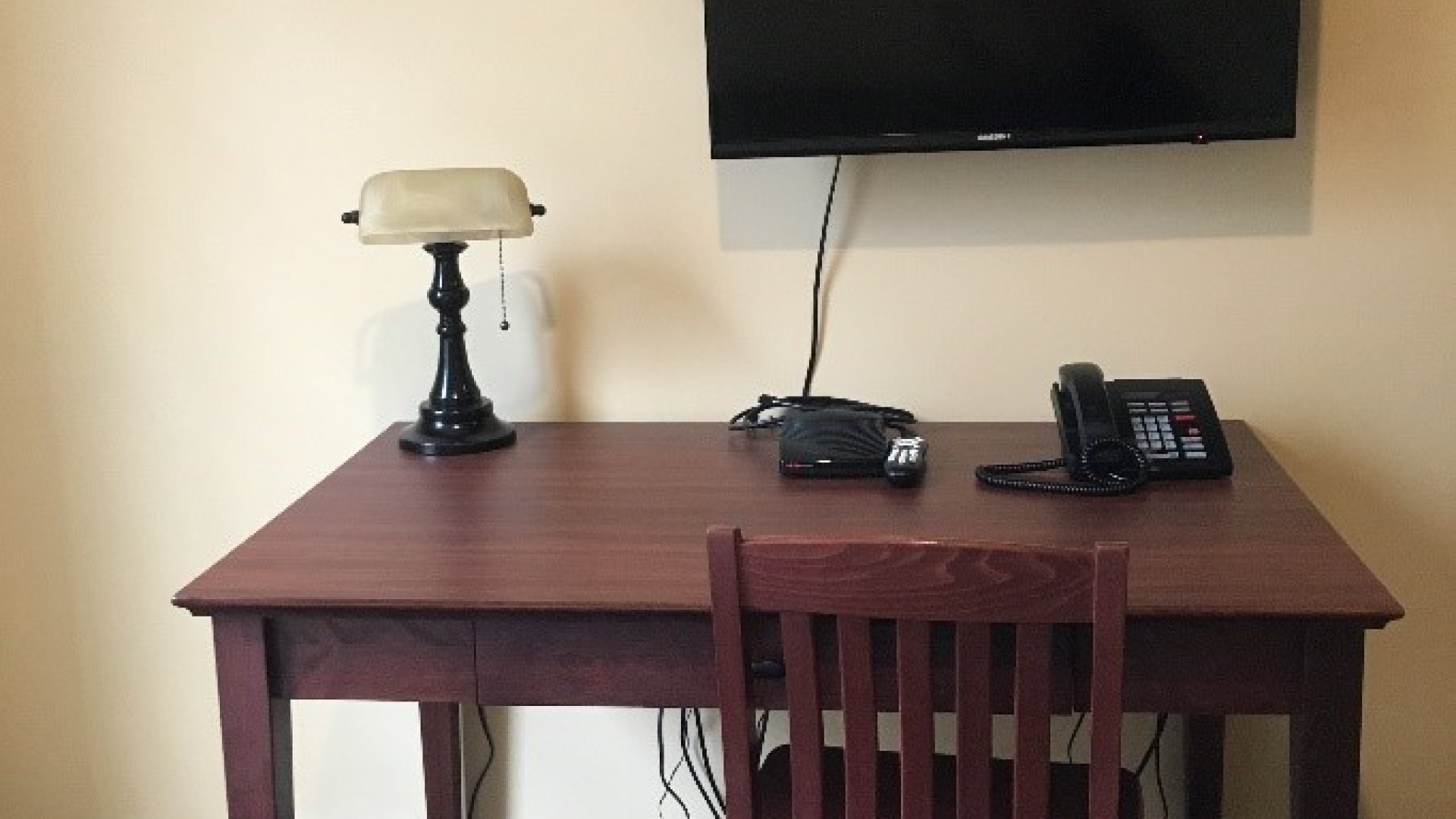Desk, lamp and TV located in a room 