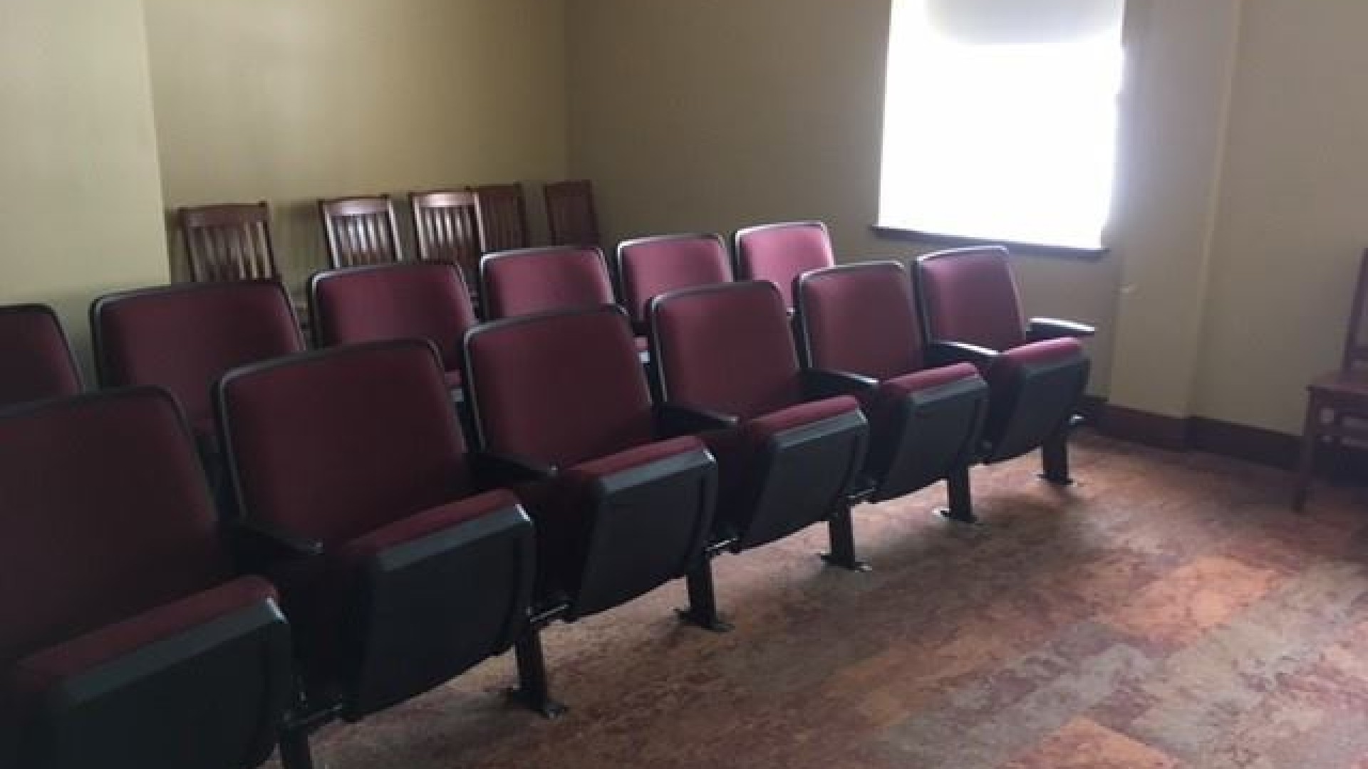Movie room with red chairs 