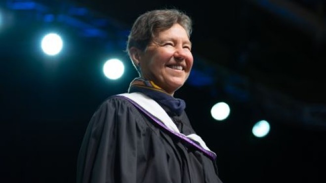 Dr. Vincent smiles on stage at Convocation 2026.