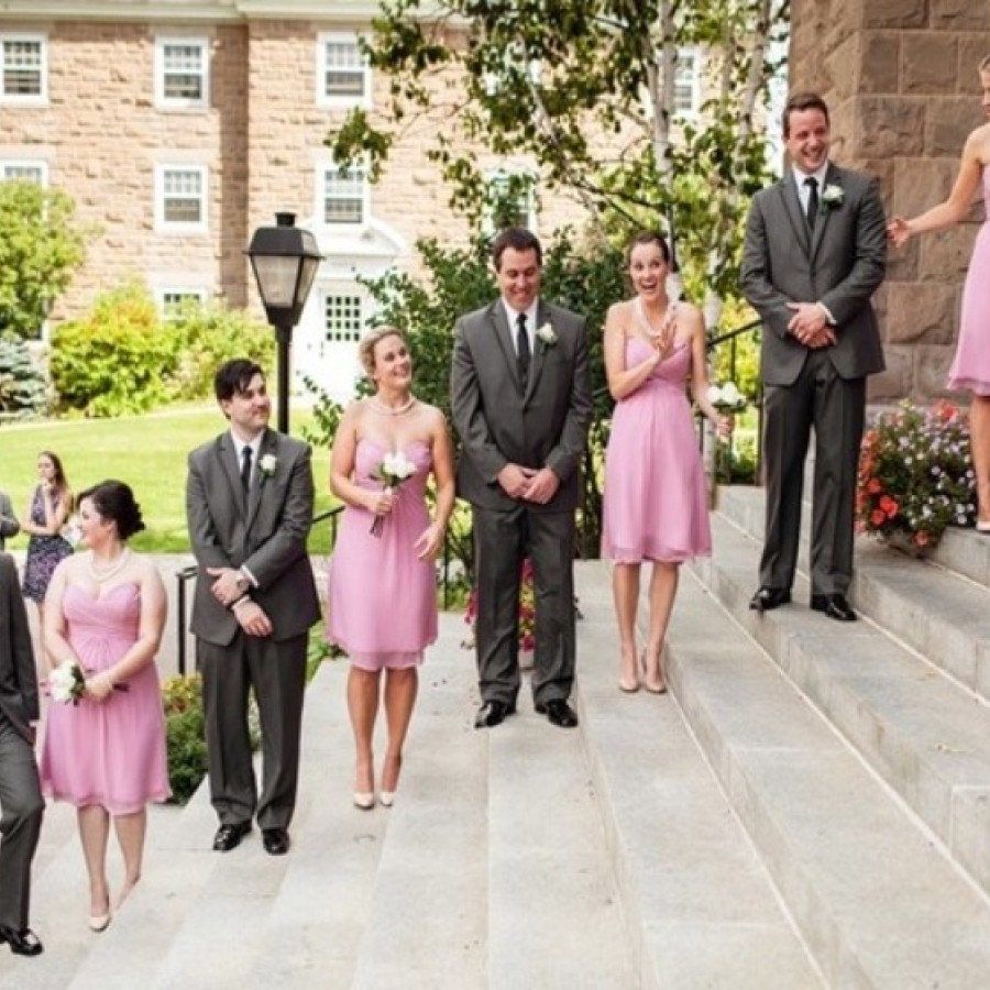 Bridesmaids and groomsmen waiting on the steps outside the building