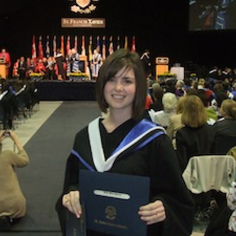 Person holding diploma smiling