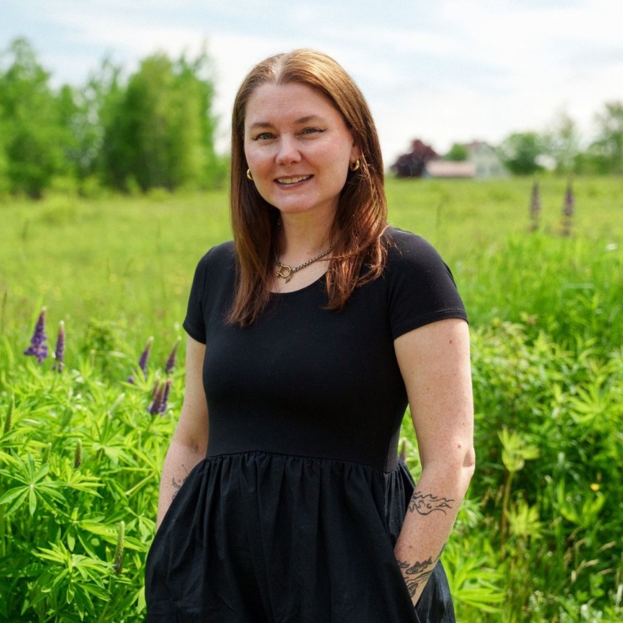 Erin Morton profile picture taken in a beautiful green field.