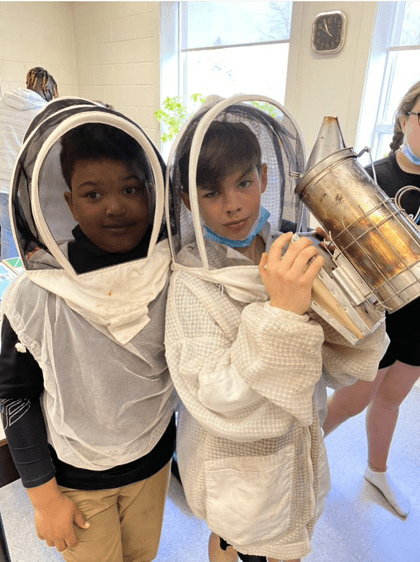 2 Students Using Protective Gear for Beekeeping