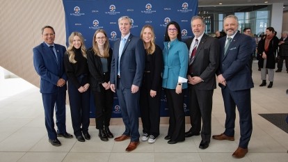 A group photo of Michelle Thompson, Tim Houston, Andy Hakin, and others after the health funding accouncement..