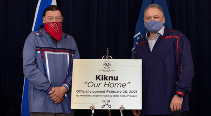 Keeper Kerry Prosper and StFX President Dr. Andy Hakin standing with a sign while wearing a mask.