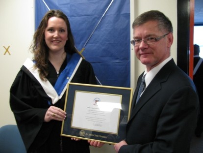 One graduated student and a man both showing a diploma
