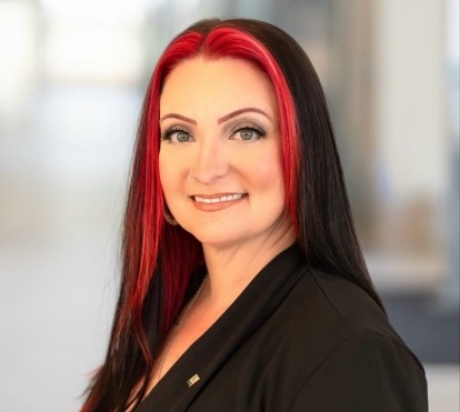 headshot of a white woman with black and red hair