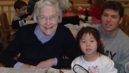 Elder person surrounded by children
